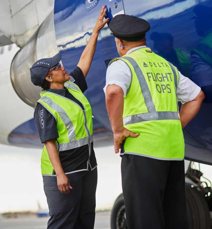 Delta aircraft mechanic and pilot inspecting aircraft