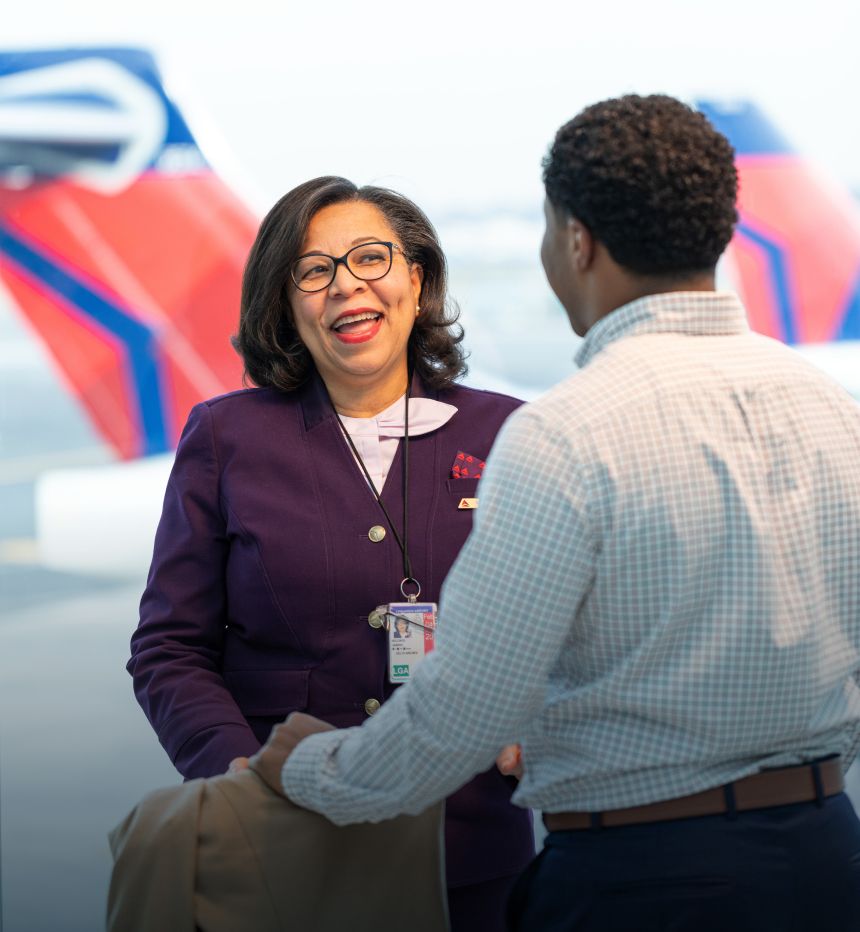 Smiling Delta staff member assisting a customer