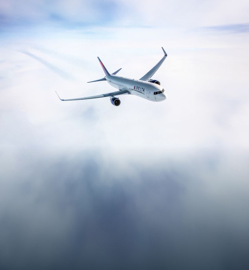 Delta airplane flying above the clouds