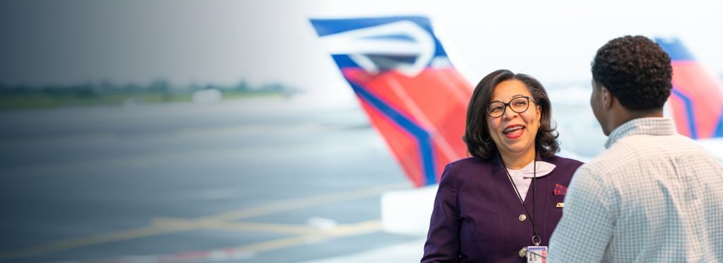 Smiling Delta staff member assisting a customer