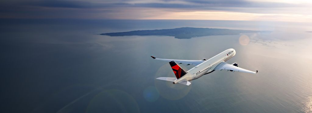 A Delta plane flies over a body of water