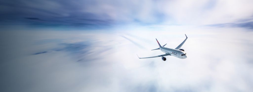 Delta airplane flying above the clouds