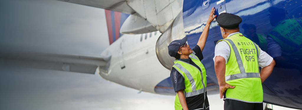 Delta aircraft mechanic and pilot inspecting aircraft