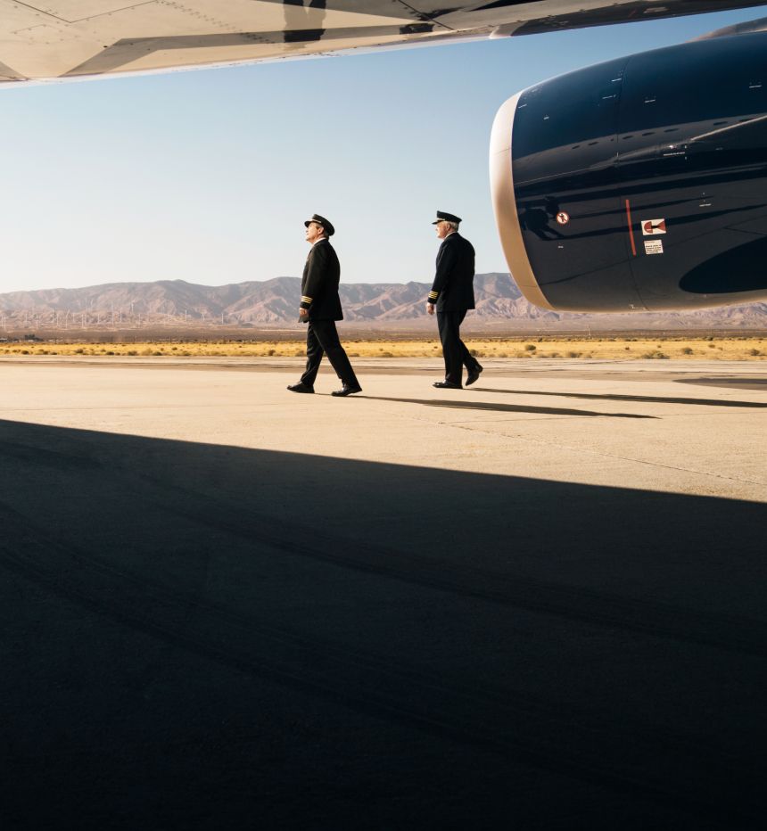 Delta pilots conducting pre-flight walk-around inspection of aircraft on tarmac