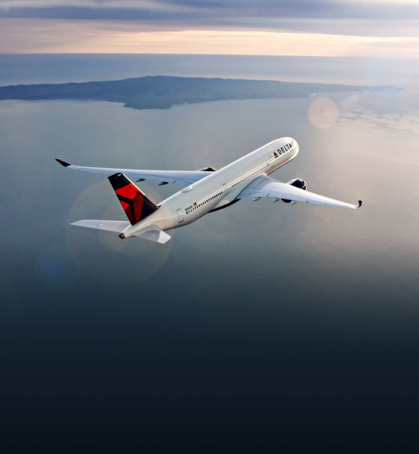 A Delta plane flies over a body of water