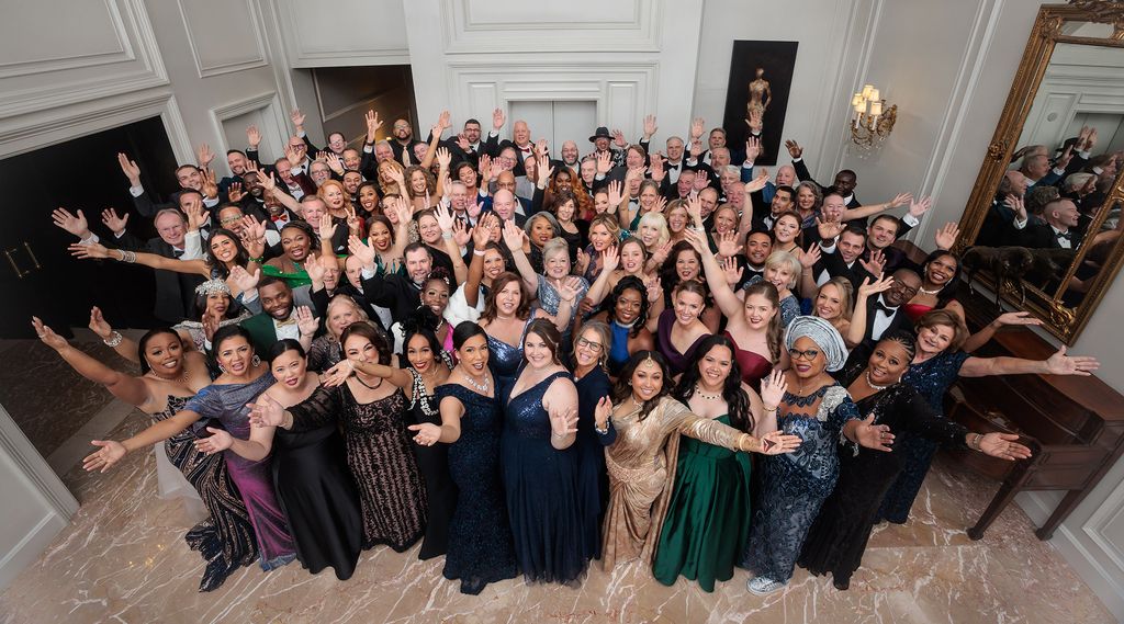 Overhead group photo of 2024 Chairman's Club honorees dressed in formal attire