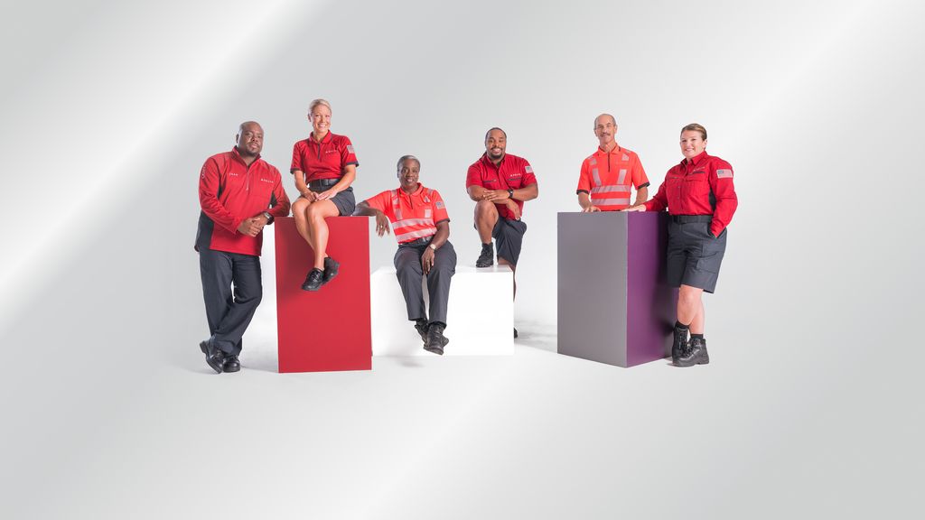 Six Delta employees dressed in ramp agent uniforms.