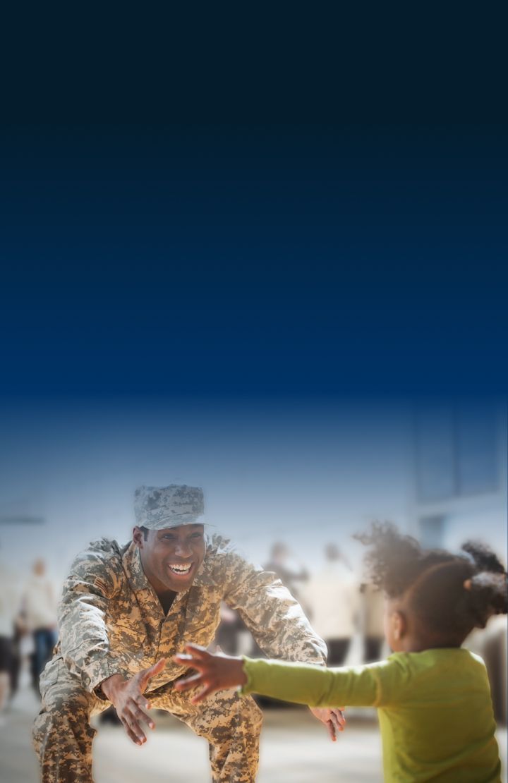 Person in military uniform crouching down with arms extended towards a child who is running towards them with outstretched arms