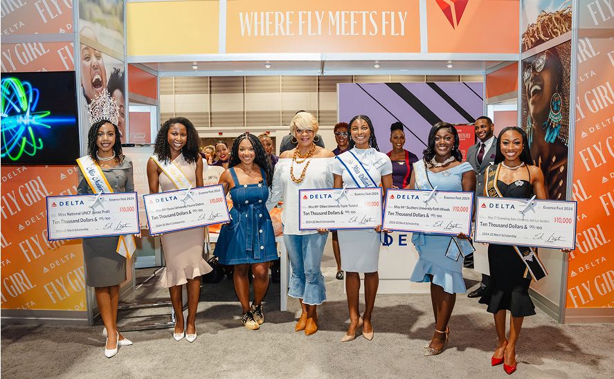 A group of ladies are holding large ceremonial checks from Delta, each for $5,000, with the memo 'Delta Scholarship Fund'.