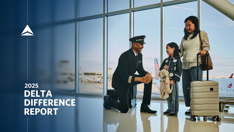 In an airport terminal, a uniformed Delta Air Lines pilot kneels to greet a child holding a stuffed toy, while an adult stands nearby with a rolling suitcase, suggesting a welcoming moment before a flight.
