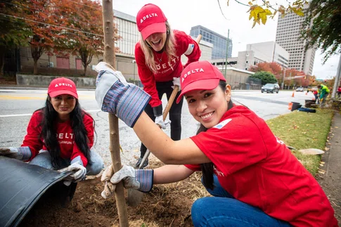 Three Delta volunteers plant trees in downtown Atlanta